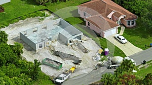 New home under construction. Unfinished frame of private house with brick concrete walls ready for mounting wooden roof