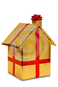 New home wrapped in gold paper with ribbon and bow