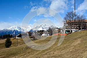 A new hotel is being built on the mountainside. Winter picturesque landscape with bright sky