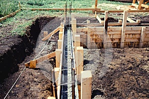 New house, building construction site, cement in foundation and reinforcement of steel bars