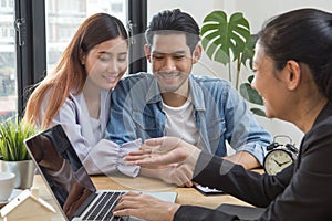 New house / home moving and relocation concept. Happy asian couple talking with apartment landlord from real estate agent / photo