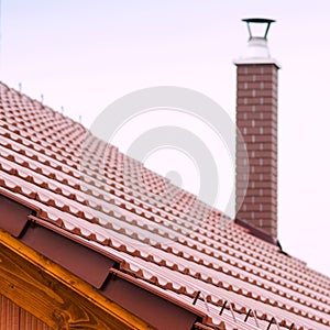 New house with orange brick wall, roof and chimney. House building worker concept.