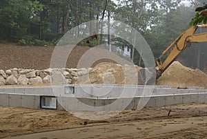 A new house poured concrete foundation after the forms are removed and concrete sealed.