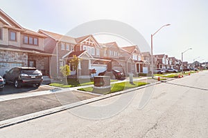 New houses along a street in a housing development on a sunny autumn day