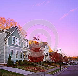 New houses on a  quiet city street in Raleigh NC with colorful Fall foliage