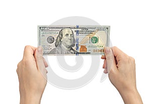 New hundred dollar bill in hands. Isolated on a white background. Woman holding american US money banknote close-up