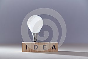 New idea generation. Insight and creative thinking. Perfect brainchild. Wooden cubes with inscription and lightbulb photo