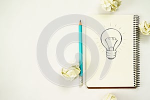 new ideas concept. notebook with three bulb, paper balls, laptop, pencil.