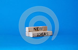 New ideas symbol. Concept word New ideas on wooden blocks. Beautiful blue background. Business and New ideas concept. Copy space