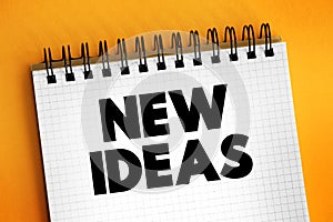 New Ideas text on notepad, concept background