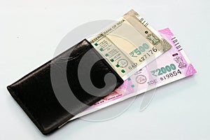 New Indian currency of 2000 and 500 rupee notes into the money purse.