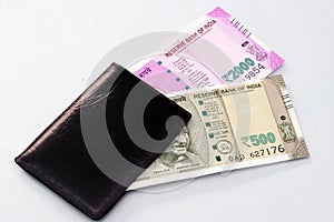 New Indian currency of 2000 and 500 rupee notes into the money purse.