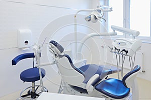 An interior of a dental office with white and blue furniture. DentistÃ¢â¬â¢s office photo