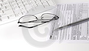 New IRS 1040 tax form, instructions, pen and keyboard. Copy space