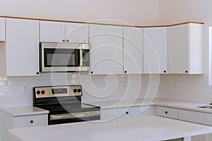 New kitchen appliances and kitchen cabinets are being installed in a newly constructed house