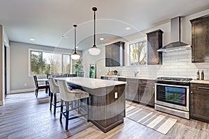 New kitchen boasts dark wood cabinets, large island