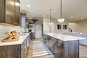 New kitchen boasts dark wood cabinets, large island