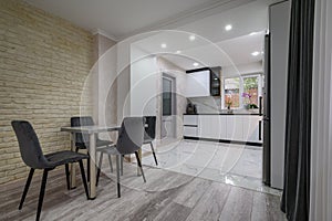 New large modern well designed white kitchen and dining room in studio flat interior