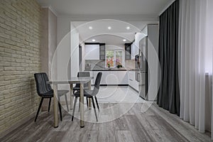 New large modern well designed white kitchen and dining room in studio flat interior