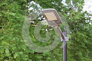 New large steel lamp poles set up in the park installed with solar cells.