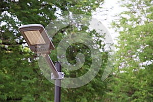 New large steel lamp poles set up in the park installed with solar cells.