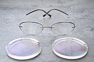 New lenses and frame for eyeglasses production lying on table in optic