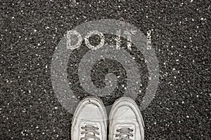 New Life Concept, Motivational Slogan with Word DO IT ! on the ground of asphalt