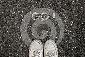 New Life Concept, Motivational Slogan with Word GO ! on the ground of asphalt