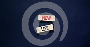 New life symbol. Concept words New life on wooden blocks on a beautiful black table black background. Business, support,