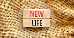 New life symbol. Concept words New life on wooden blocks on a beautiful canvas table canvas background. Business, support,