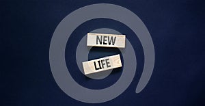 New life symbol. Concept words New life on wooden blocks on a beautiful black table black background. Business, support,