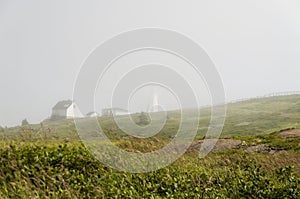 The new lighthouse nearly obscured by fog.