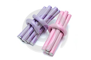 Lilac and pink  hair curlers on a white background