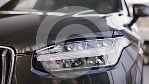 New luxury car Volvo XC90 in oficial dealership, left headlight