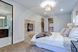 New luxury custom built home with white master bedroom.