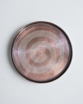 New luxury cutlery view from above on a isolated white background. Top view. Copper saucer. Trendy plate pastel shades