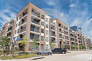 New luxury multistorey apartment community with parked cars near Dallas, Texas