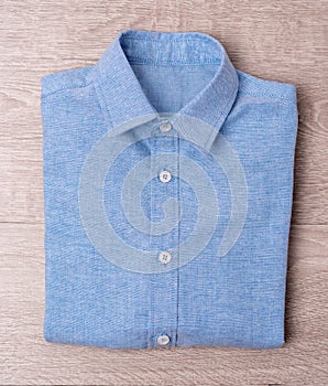 New man blue shirt on wood background