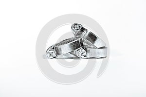 New metal hose clamps with threaded connection for pipes, stainless steel, small size on isolated white background close-up