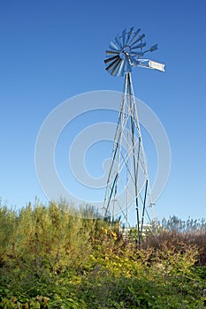 New metal windmill in a garden.