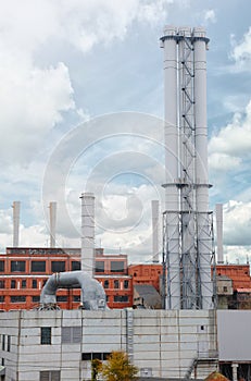 New metallic pipe gas boiler house on background blue sky. the concept of progress in the energy industry. Factory Pipes