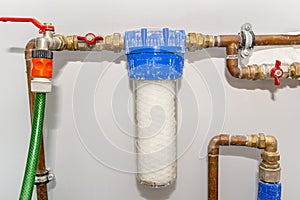 New 20 micron water string cartridge placed in front of the main water intake in the house. photo