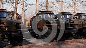 New military trucks are in a row on the site. Army equipment.