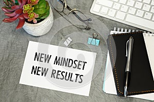 New mindset New results - lettering on paper on the desktop, notepad, pen and keyboard