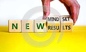 New mindset and results symbol. Businessman turns wooden cubes and changes words `new mindset` to `new results`. Beautiful whi