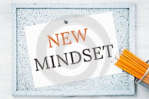 New mindset text on notice board with pencils