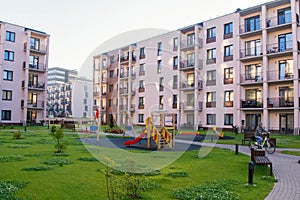 New modern apartment complex in Vilnius, Lithuania, modern low rise european building complex with outdoor facilities. The girl is