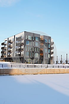 New modern apartments building at Kalamaja district during winter snowy sunny day. Tallinn, Estonia, Europe. January