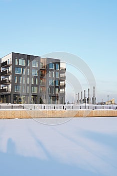 New modern apartments building at Kalamaja district during winter time at snowy sunny day. Tallinn, Estonia, Europe