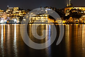 new modern architecture buildings at the banks of lake long exposure shot at night